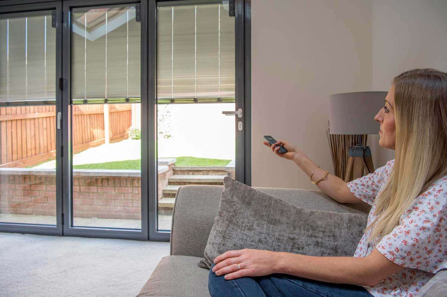 Integral Blinds for Bifold Doors: remote controlling pleated blinds inside bifold doors from a sofa