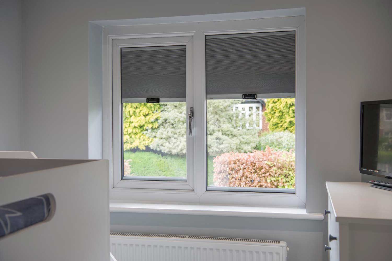 Blinds in Glass in Baldock: grey integral blinds in a bedroom window