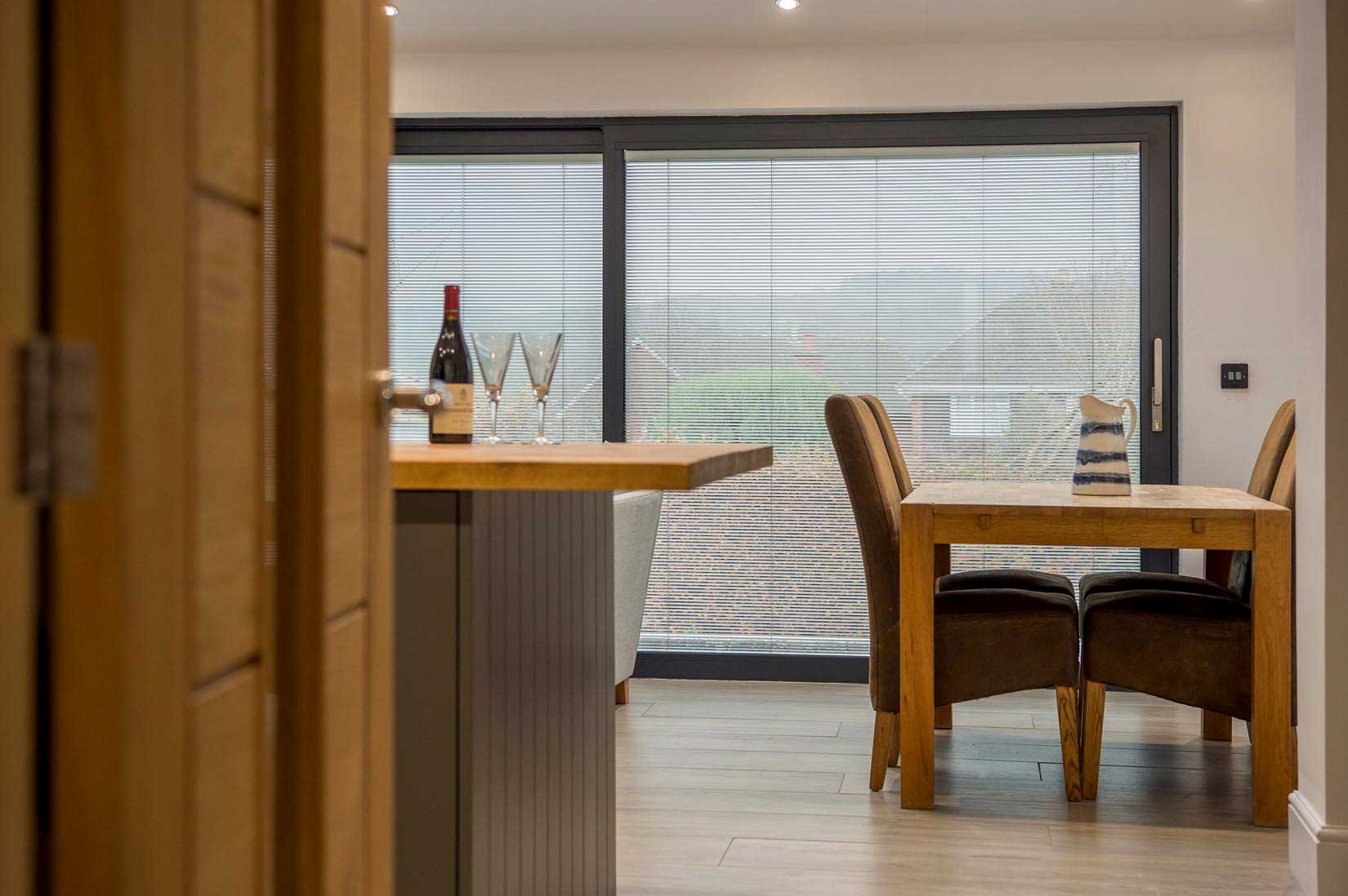Blinds in Glass in Baldock: integral blinds in dining-room patio doors viewed through an oak door