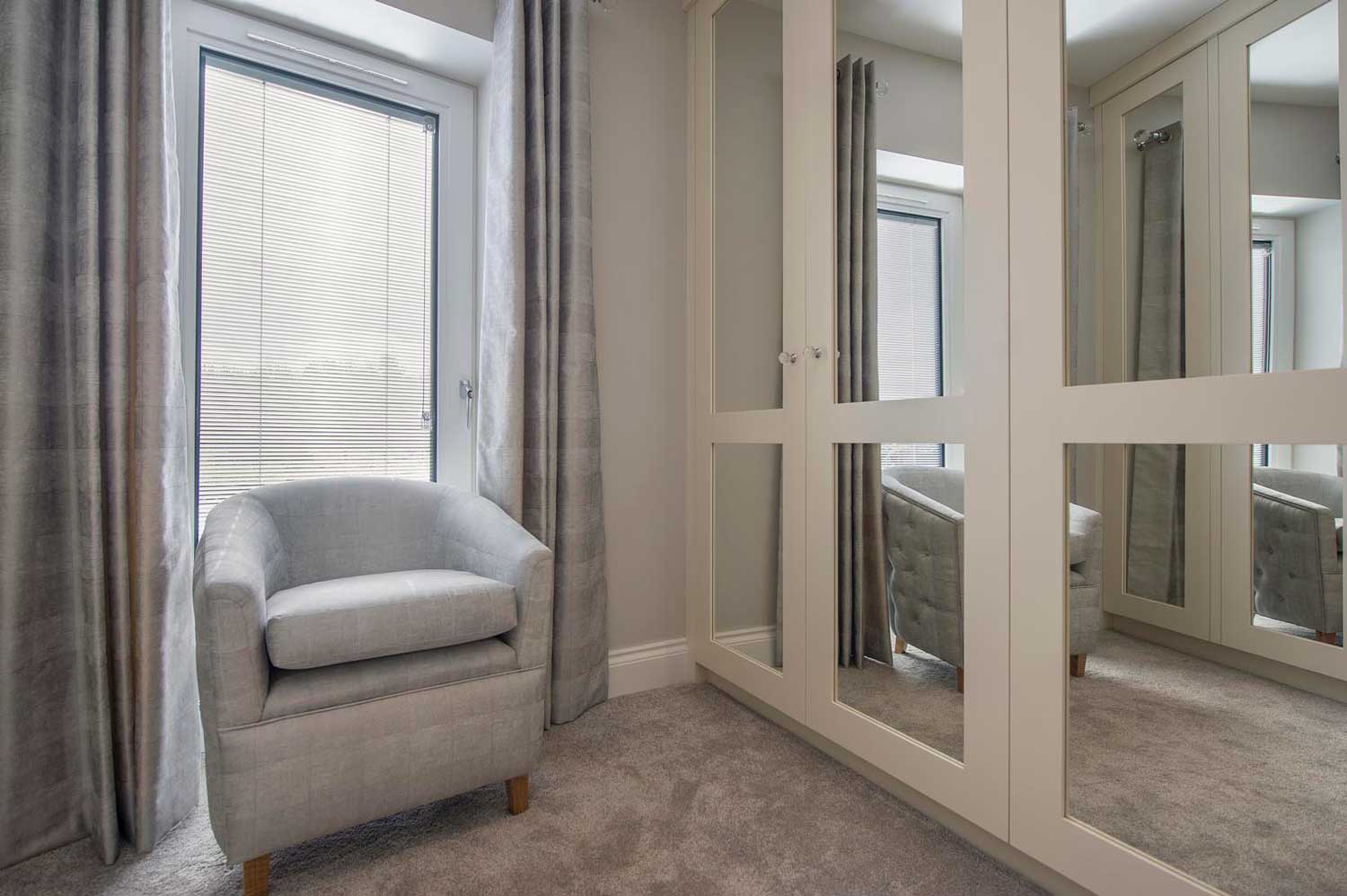 Blinds in Glass in Baldock: integral blinds in a dressing-room window beside mirrored wardrobes
