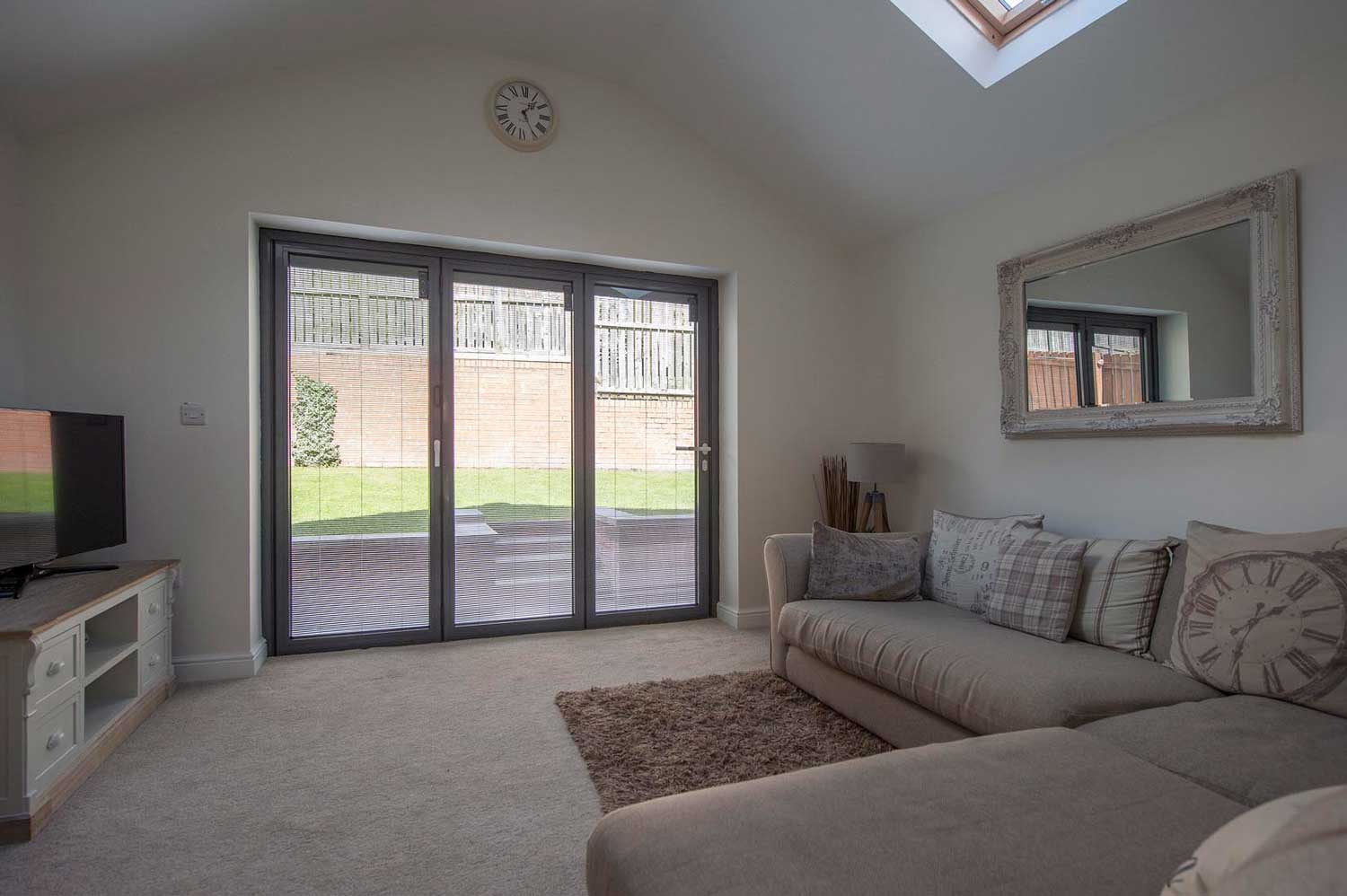 Blinds in Glass in Baldock: integral blinds in living-room bifold doors below a skylight