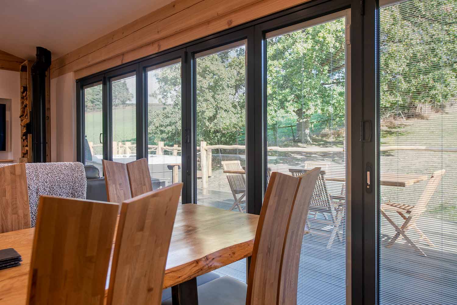 Blinds in Glass in Baldock: integral blinds in anthracite bifold doors off an oak dining area