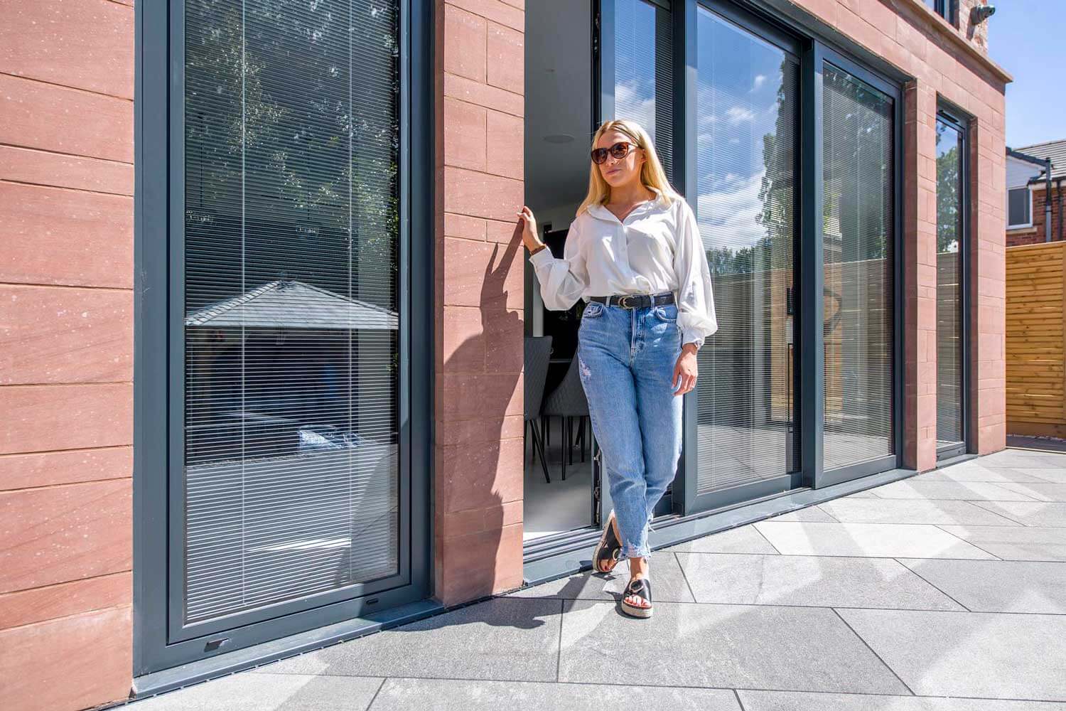 Blinds in Glass in Baldock: integral blinds in the sliding doors of a sandstone-clad house